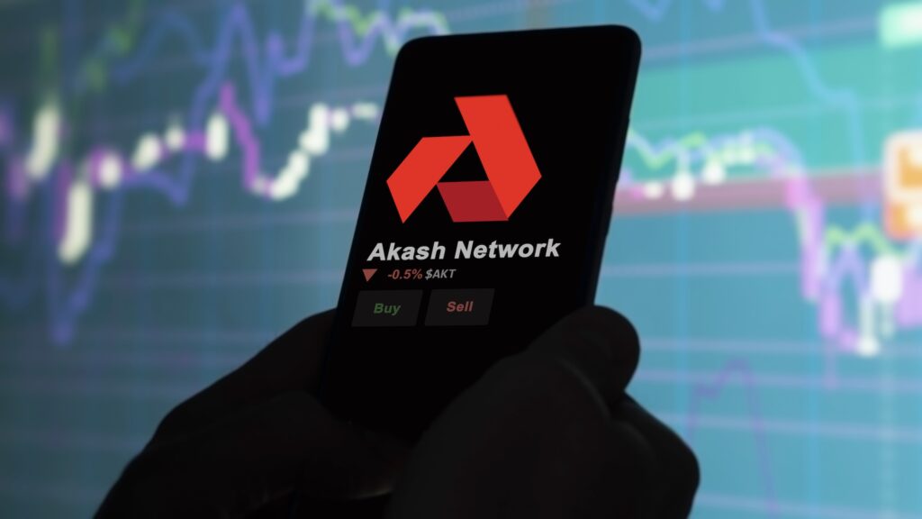 Akash Network - Crypto-Globe.com Phone screen showing Akash Network logo, -0.5% AKT, and Buy/Sell buttons with a blurred trading chart background.