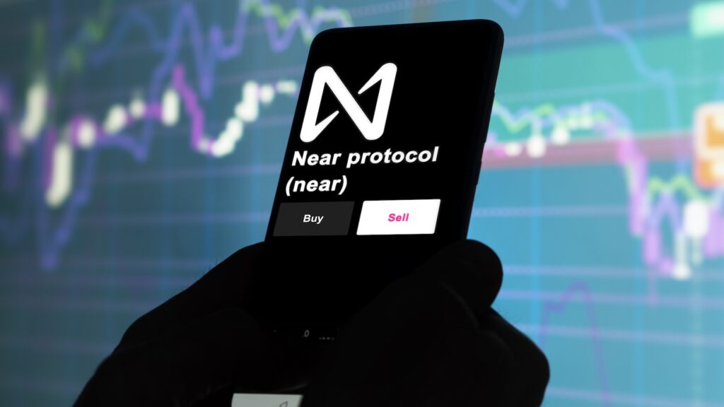 Near - Crypto-Globe.com Smartphone screen showing Near Protocol logo and Buy/Sell buttons over a colorful financial chart.